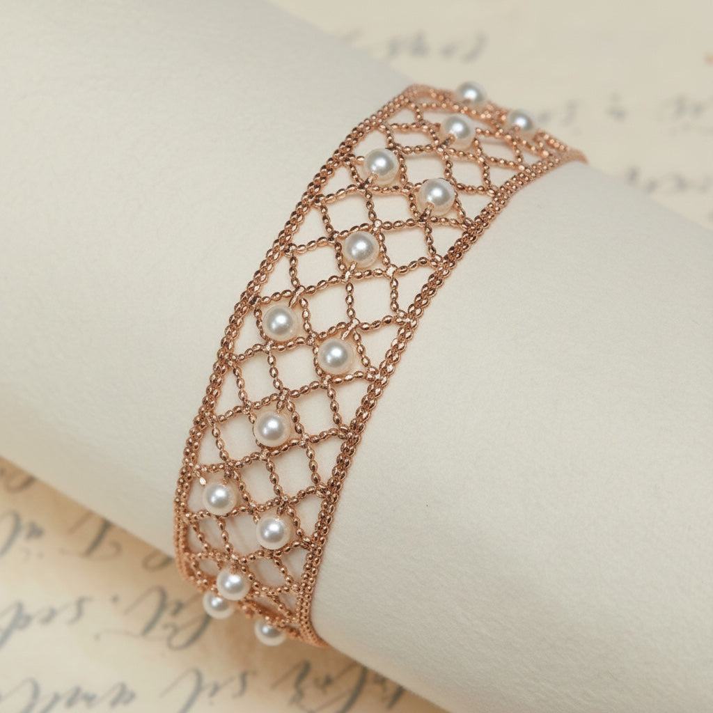 BoxUnboxed 18k yellow gold lace lattice bracelet with Akoya pearls. Features a flexible, hand-woven design with 3-3.5mm pearls.