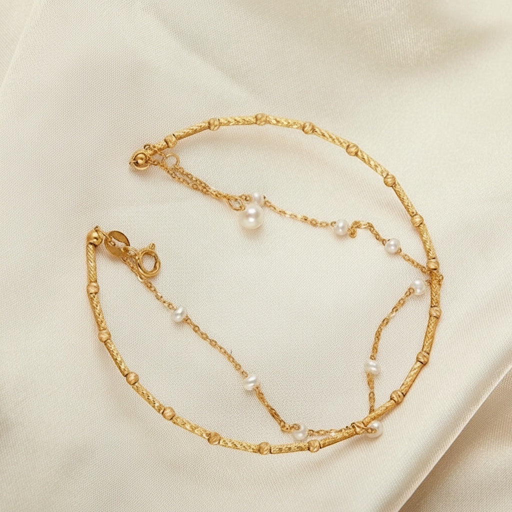 BoxUnboxed Artisanal Signature dual-layer bracelet in 18K gold with freshwater pearls and textured chain.