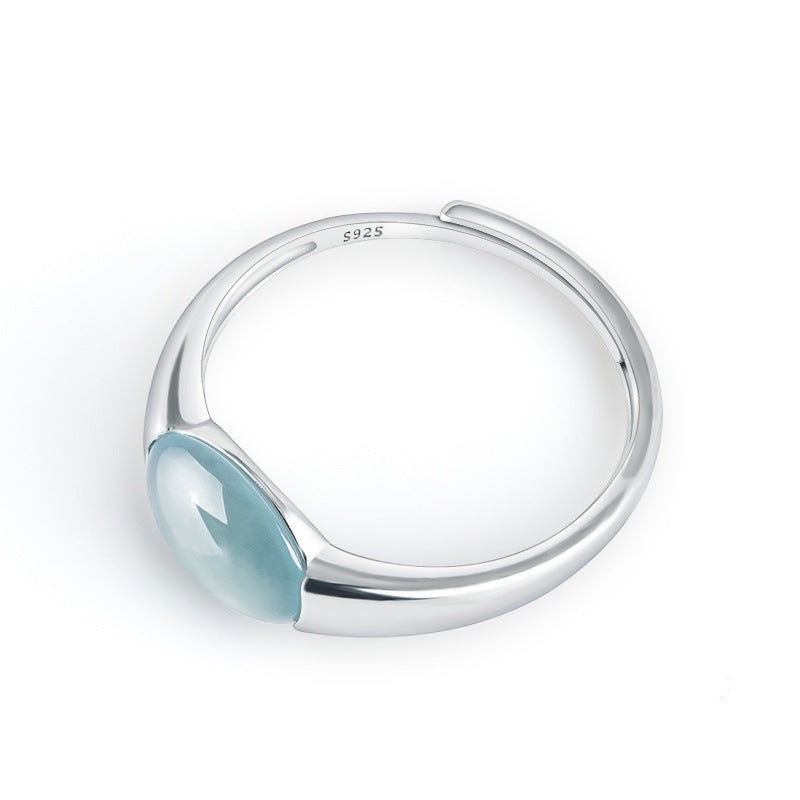 BoxUnboxed Aurora Ring: adjustable sterling silver ring with a smooth, oval, translucent teal-blue jadeite cabochon stone.